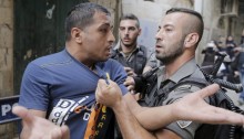 An Israeli police officer detains a Palestinian protester in East Jerusalem [Photo Credit: Reuters/Ammar Awad]