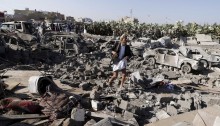 A Yemeni man picks his way through rubble [Photo Credit: Khaled Abdullah/Reuters]
