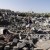 A Yemeni man picks his way through rubble [Photo Credit: Khaled Abdullah/Reuters]
